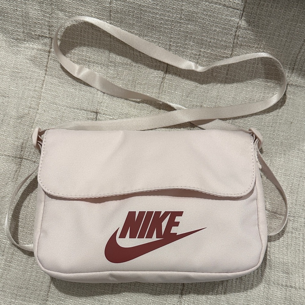 Nike Light Pink Crossbody Bag with Adjustable Straps and Several Pockets